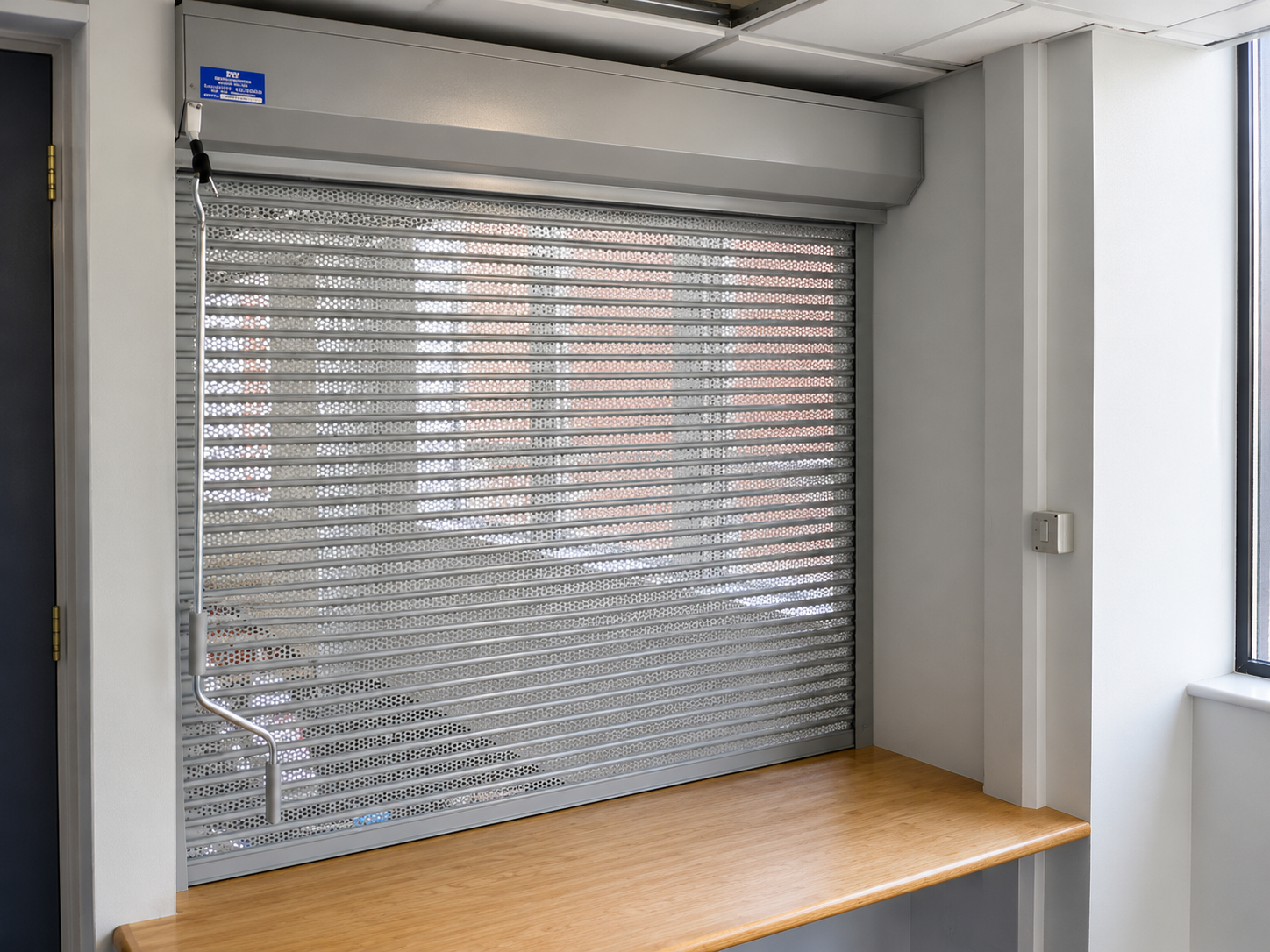 Perforated rolling shutter slat profile and surface finish — corrosion-resistant detail